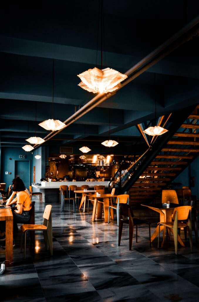 pexels-photo-3887985-3887985 Elegant modern café with warm lighting and contemporary decor, creating a cozy atmosphere.